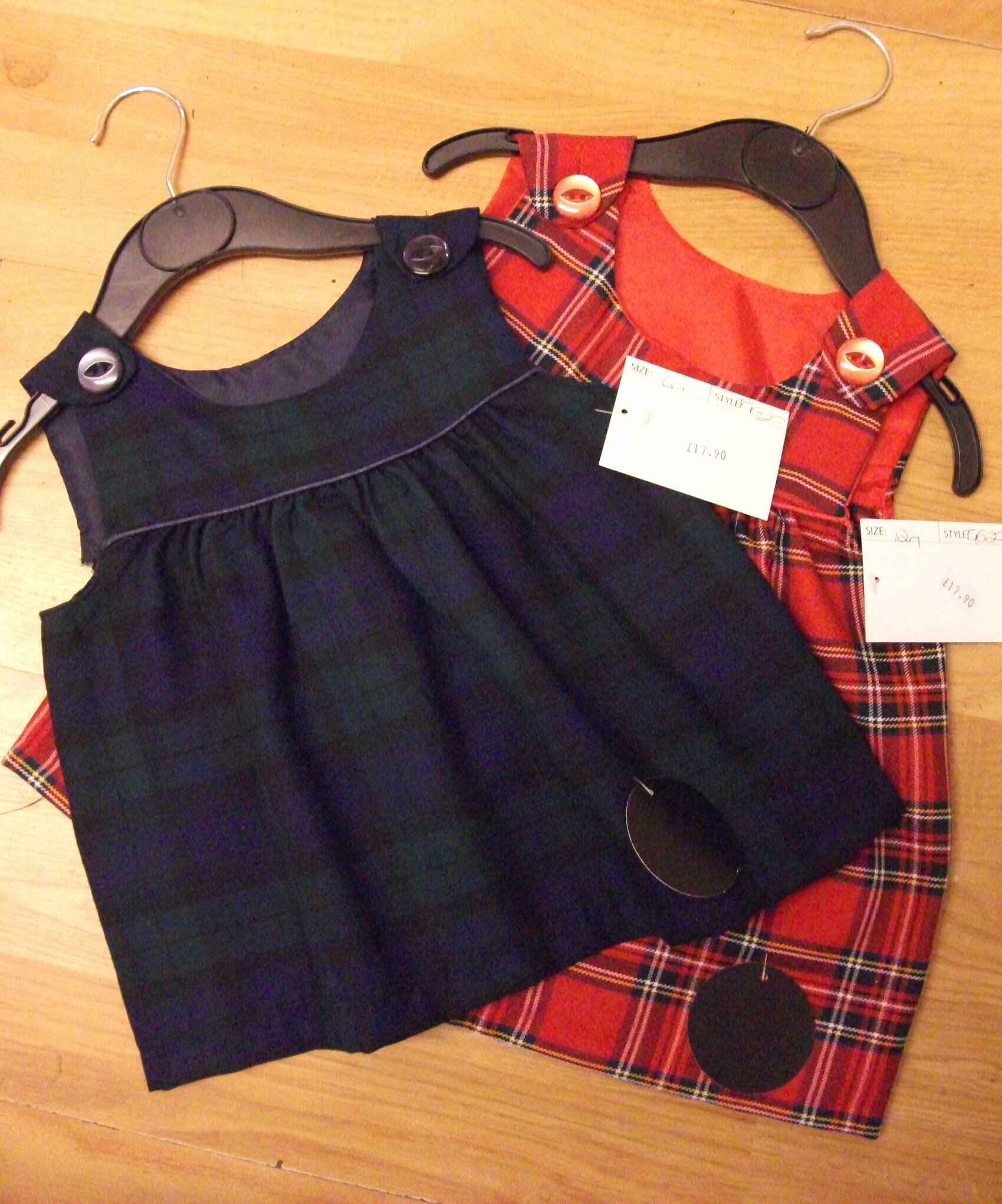 Two tartan dresses; one blue and one red tartan. Photo