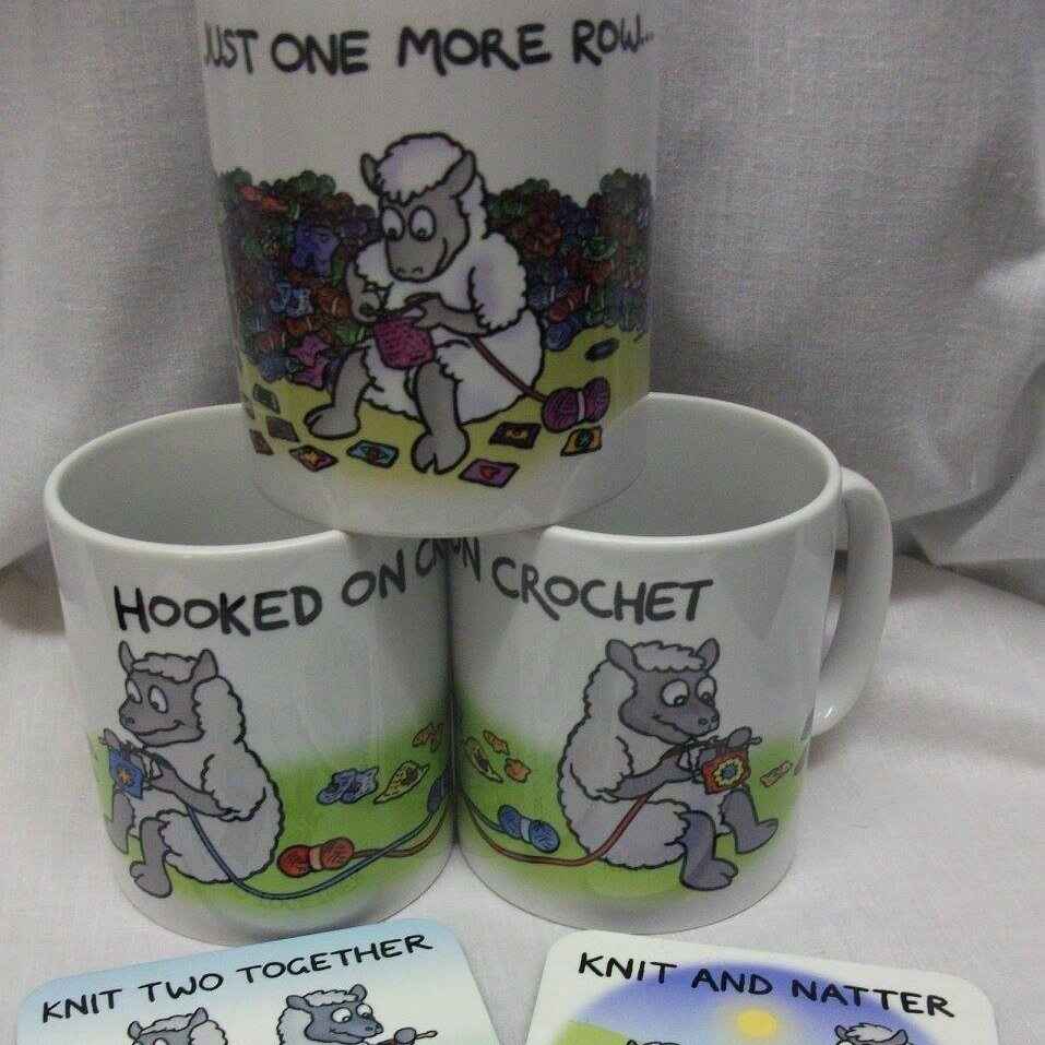 Three mugs stacked with a cartoon sheep doing crochet. Above each sheep is text like “Just one more row...”. Photo